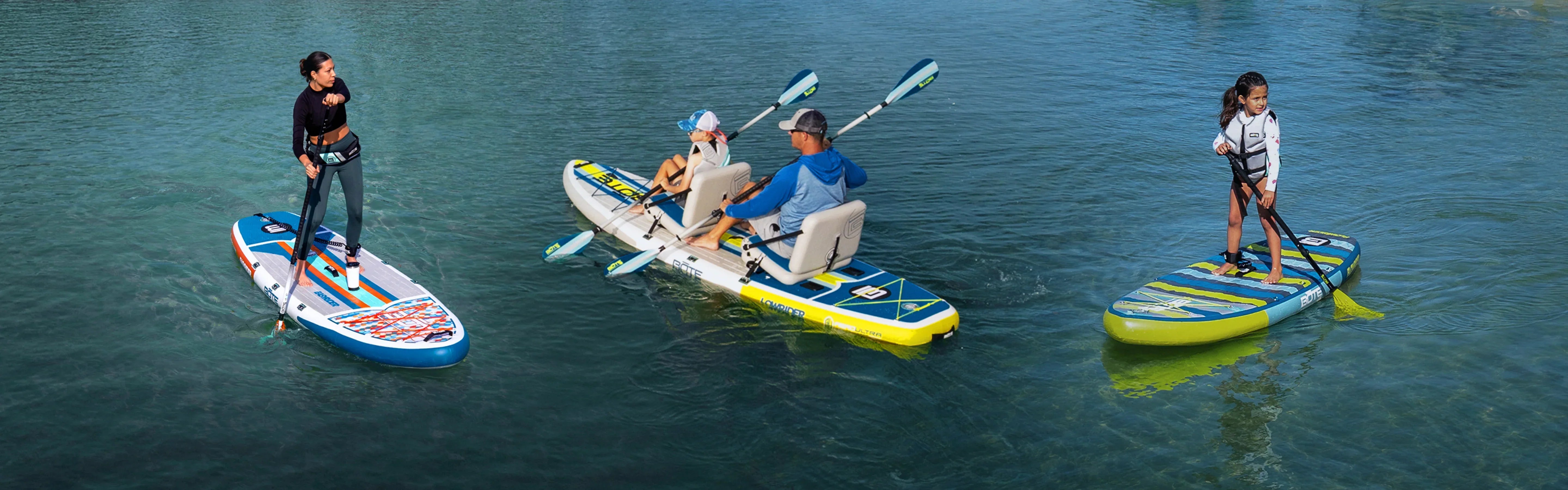 People on standup Bote paddle boards on a lake