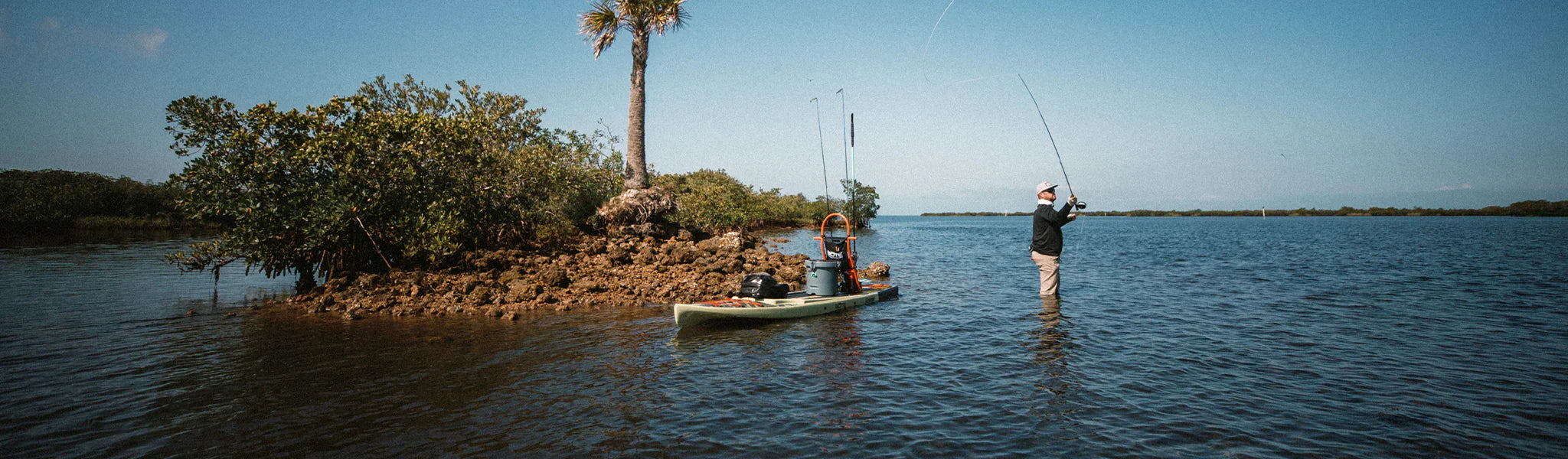 Man fishing with his Rackham Gatorshell Paddle Board