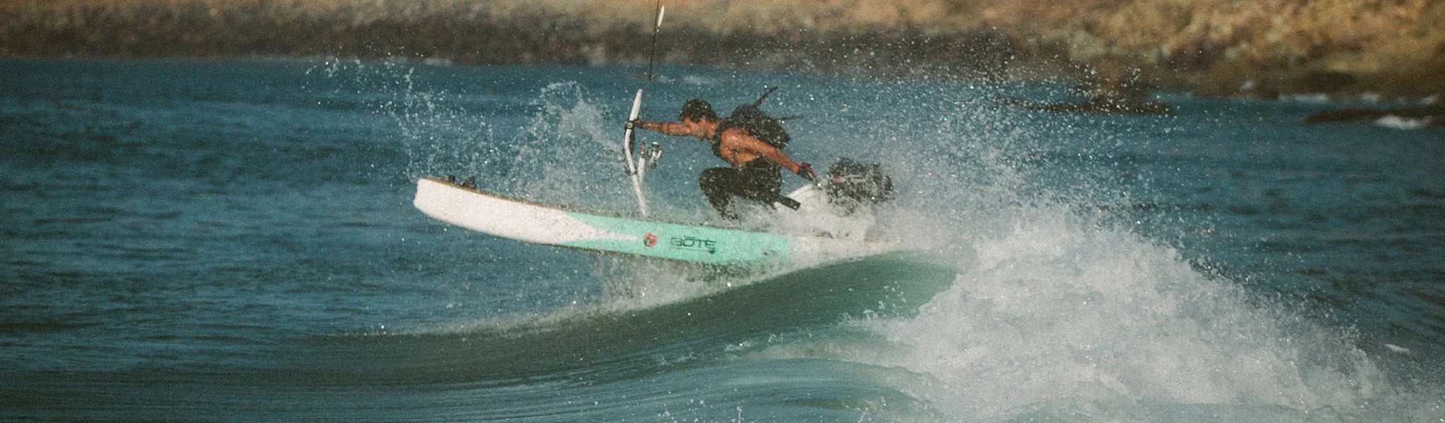 BOTE micro skiff in ocean riding a wave