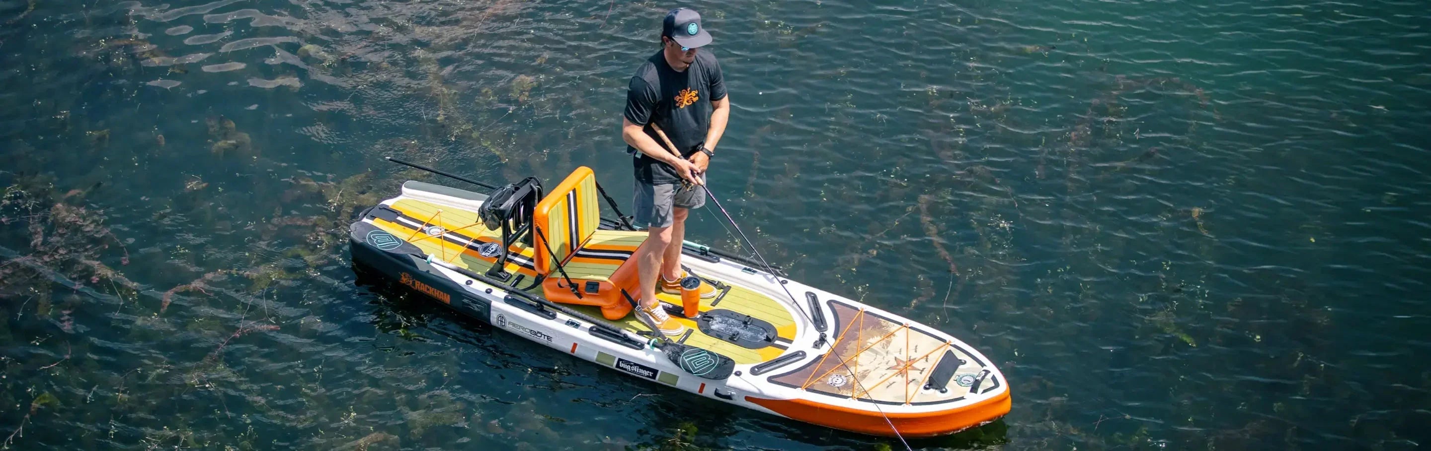 Bote pedal drive paddle board on lake with person fishing