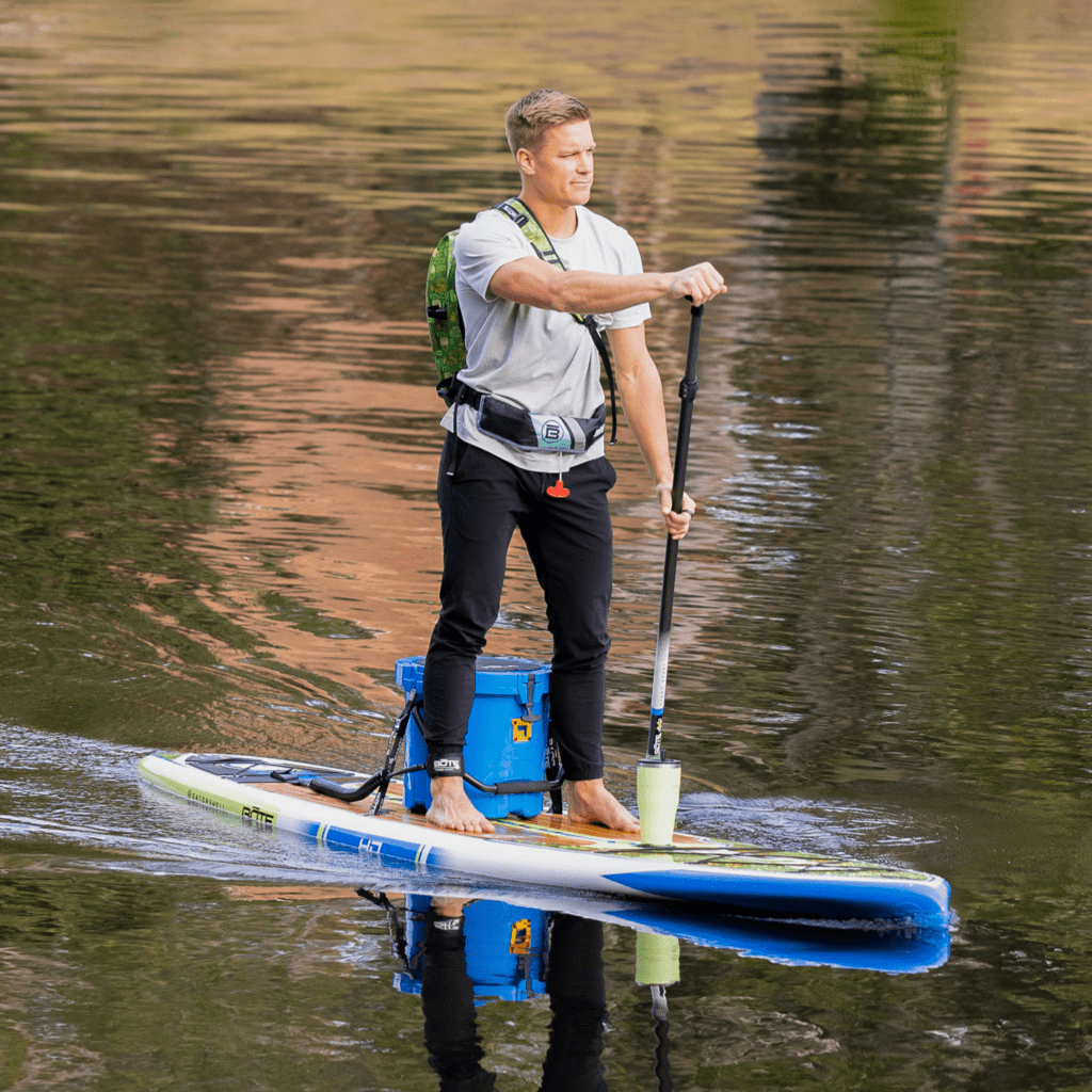 A guy paddling on the HD 12′ Native Nalu Paddle Board