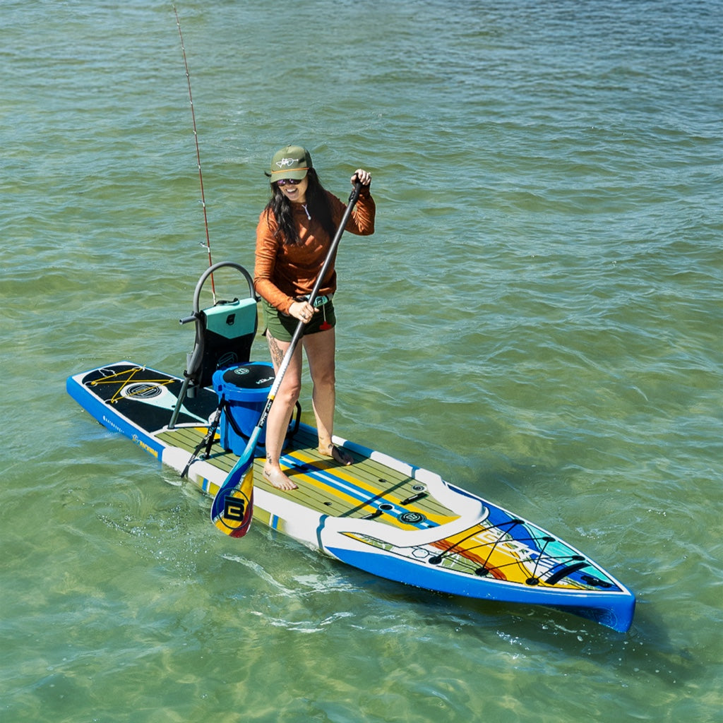 A person paddling on a Rackham 12′ Native Fusion Paddle Board