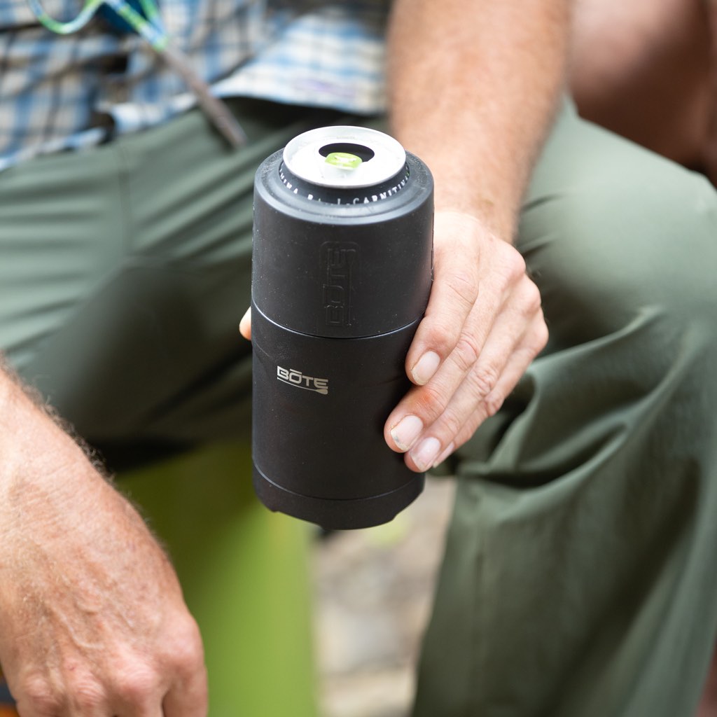 A person holding a MAGNEChill Can Cooler Switch with a drink in it