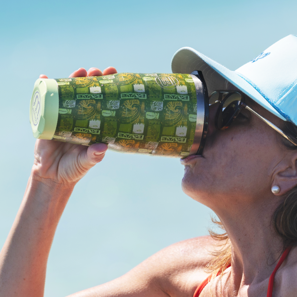 Woman drinking from MAGNETumbler 32oz Native Nalu with MAGNEPOD base visible.