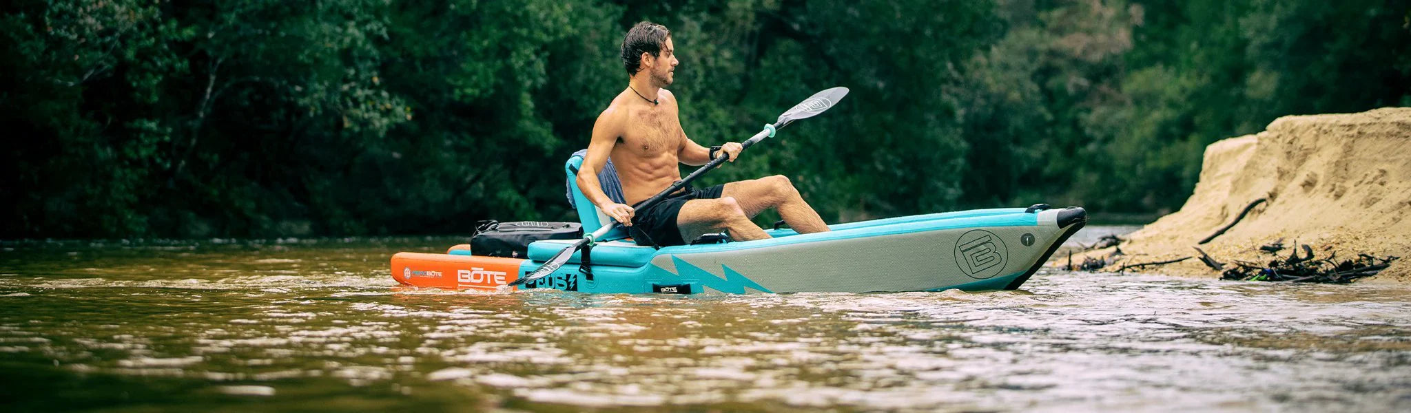 Man on DEUS Inflatable Kayak with Kayak Paddle