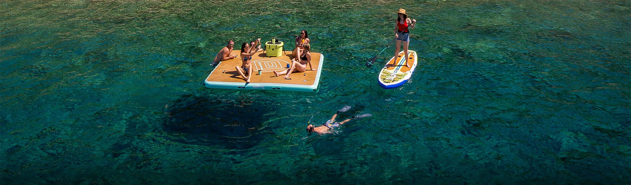 People sitting on a Hangout Dock in clear calm water.