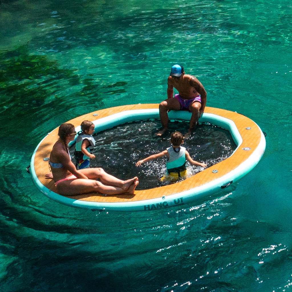 Lifestyle image of people lounging in the Inflatable Hangout Water Hammock 10 Classic