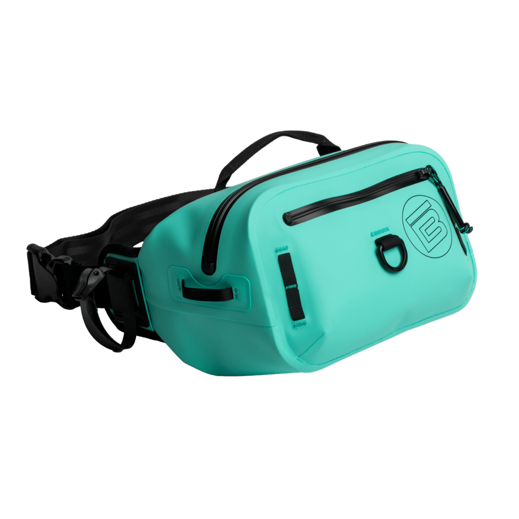 Angled side view of Highwater Belt Pack Seafoam with black zippers and top handle.