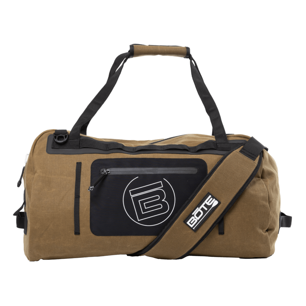 Front view of Highwater Duffel Last Cowboy in tan with black front pocket and shoulder strap.