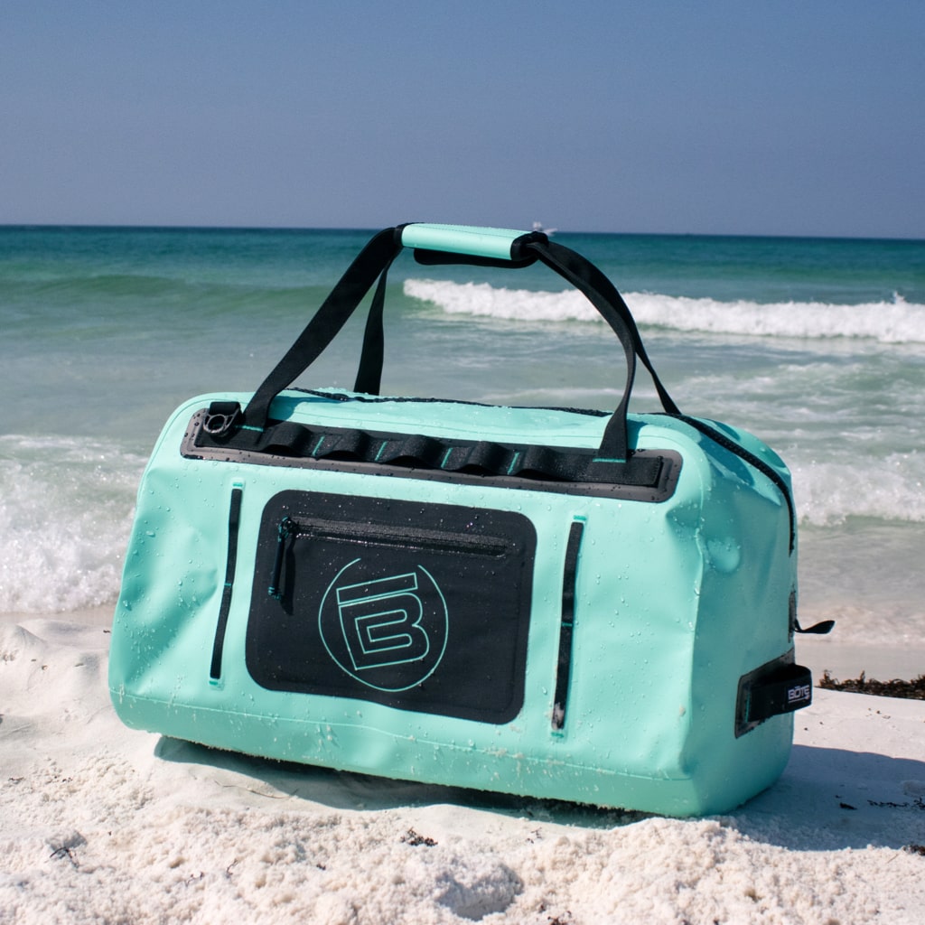 Highwater Duffel Seafoam sitting on the beach