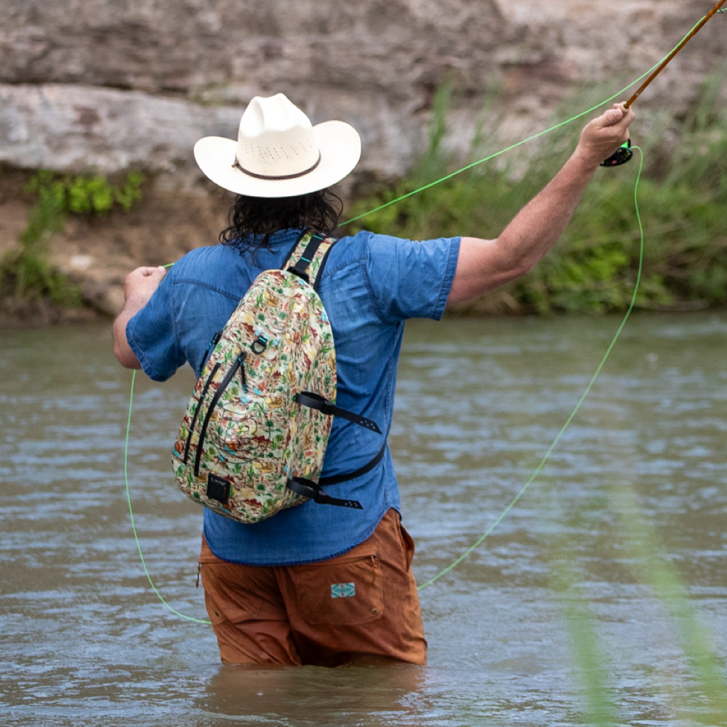 Highwater Slingpack Native Sendero worn while fly fishing, showing full desert-themed print.