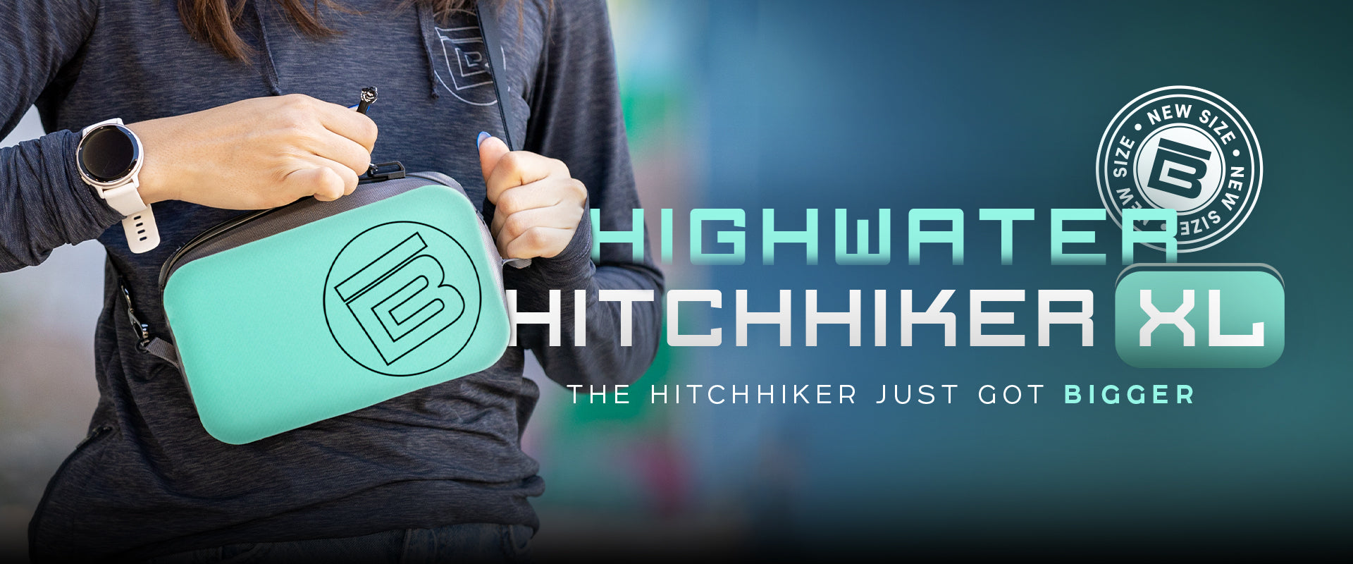 Person holding a Highwater Hitchhiker XL in seafoam.